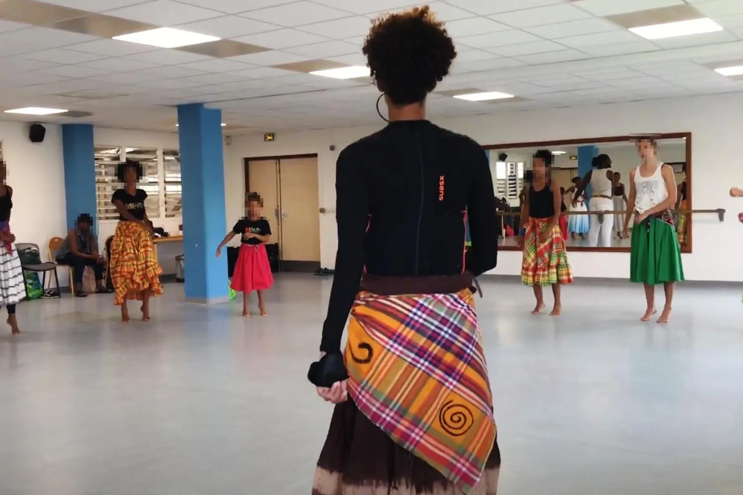 Atelier de danse dans une salle scolaire, élèves en cercle