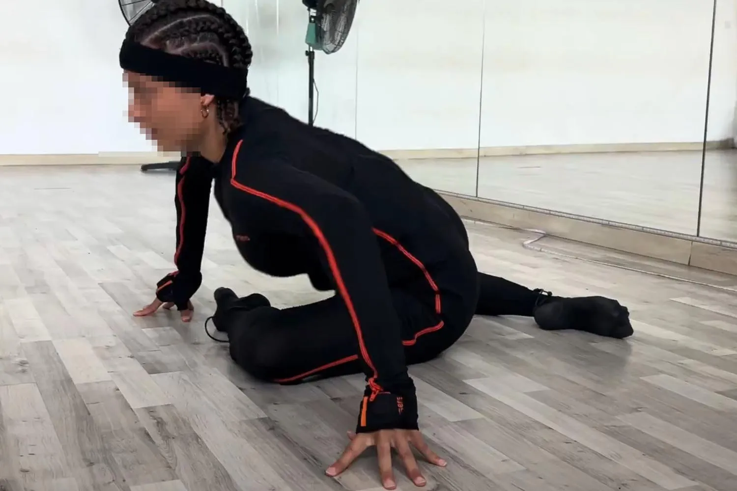 Performer braced against the floor during a dynamic movement