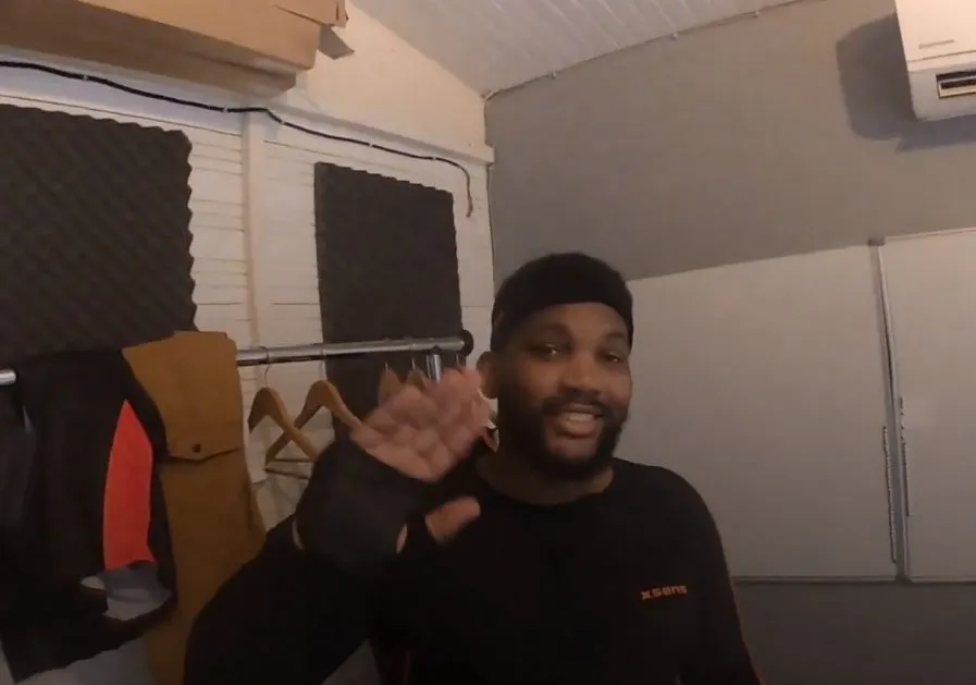 Performer in a motion capture suit waving in the studio
